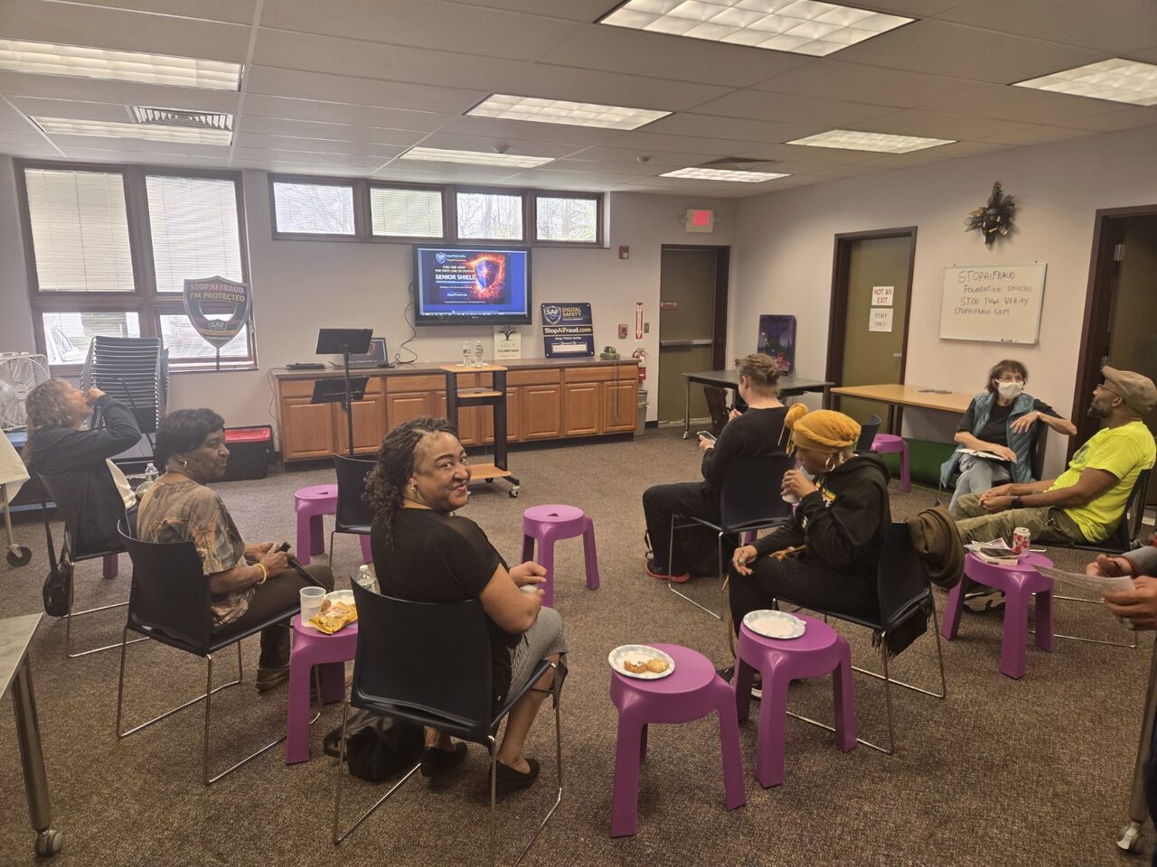 Wide view of community attendees seated during a live SAF AI fraud awareness training session.